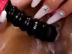 Tanned girl with shaved pussy masturbating using oil and toy